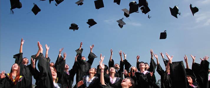 graduates throwing hats up