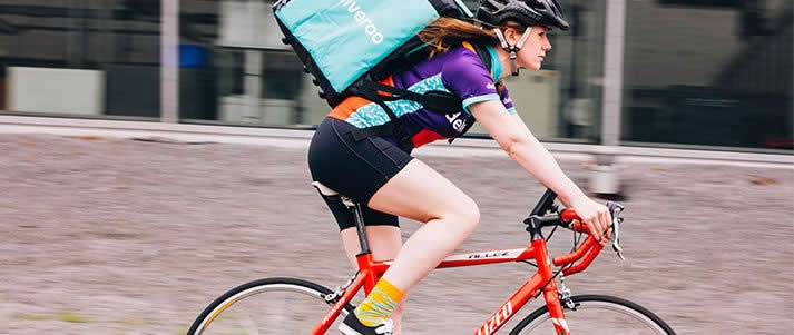 woman on bike as deliveroo rider