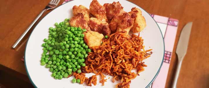 Chicken nuggets, peas and sweet potato curly fries